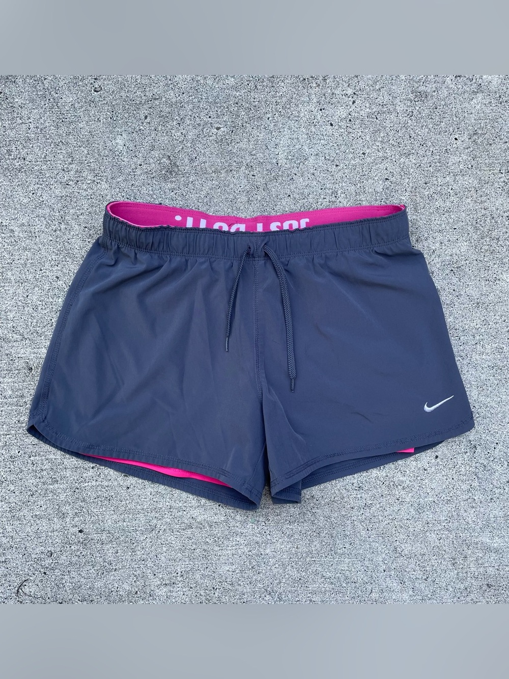 grey and pink Nike tennis shorts